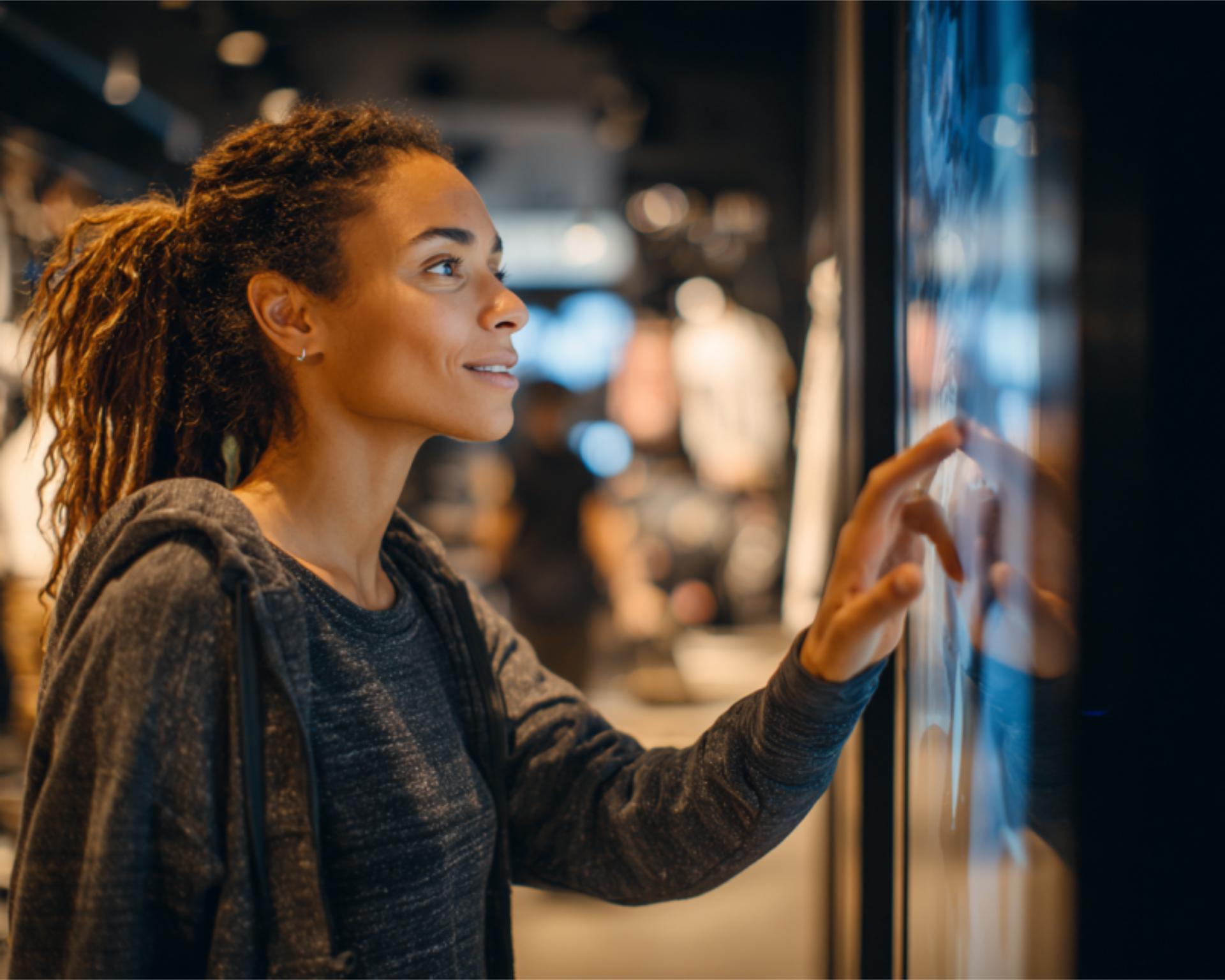 Shopper Pausing at Interactive Screen in Store A c 4